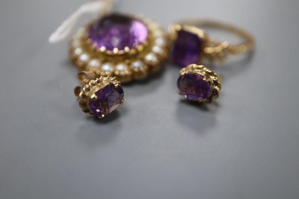 A modern 9ct gold, amethyst and seed pearl set oval pendant, a pair of 9ct and amethyst earstuds and a plated dress ring,